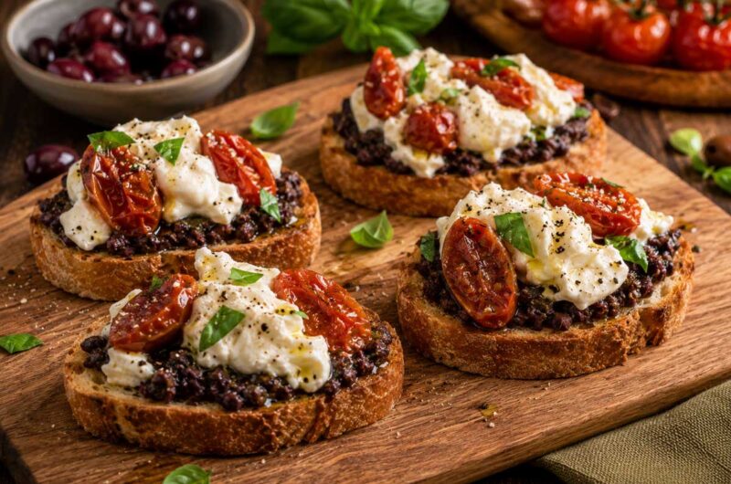 Mediterranean Crostini with Black Olive Tapenade, Burrata & Confit Tomatoes